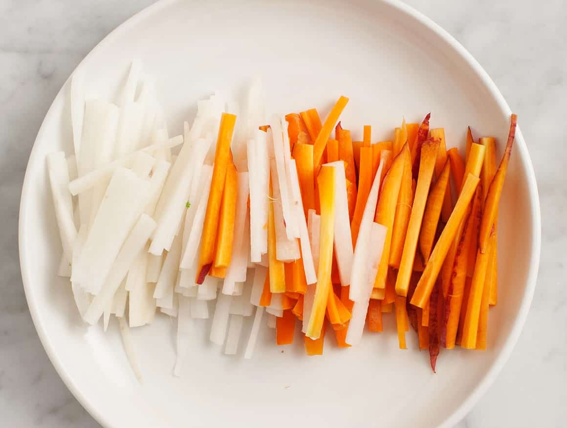 Thinly sliced carrot and daikon on a plate