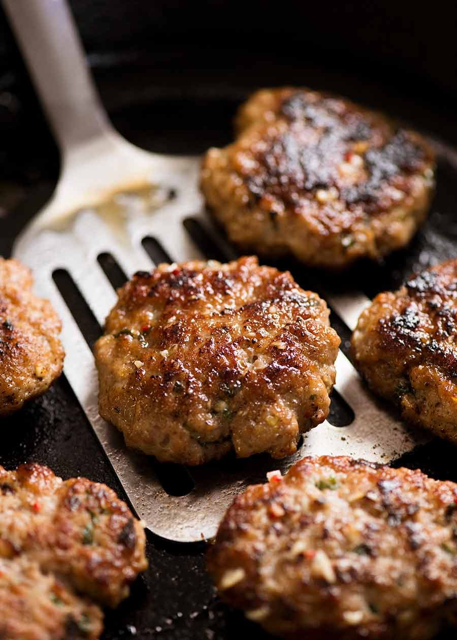 Bun Cha - Vietnamese Meatball patties in a black skillet, fresh off the stove