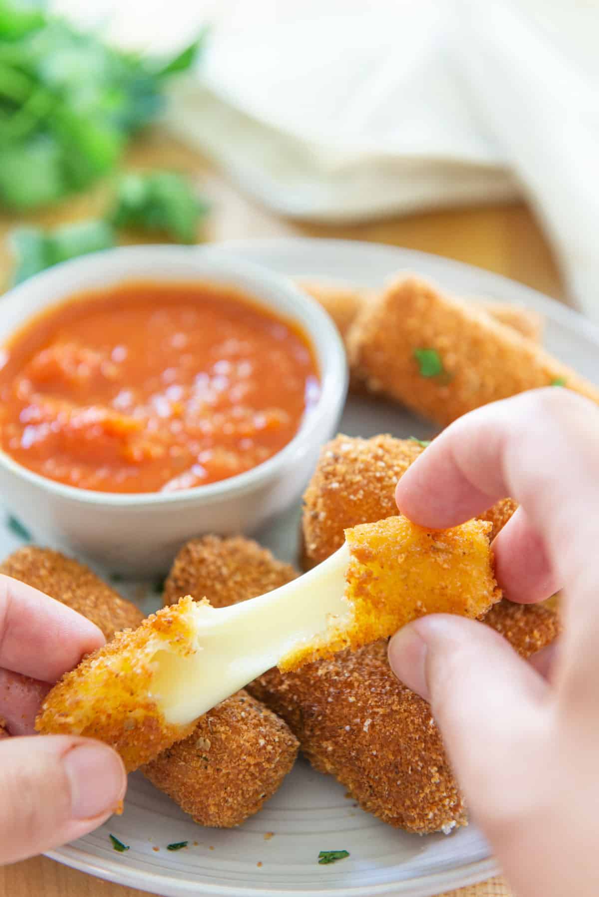 Homemade Mozzarella Sticks on a Plate with Ramekin of Marinara