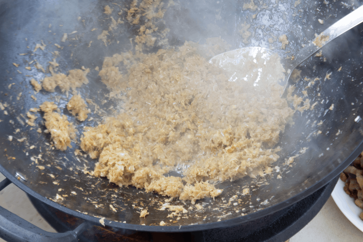 Blitzed lemongrass in a wok.