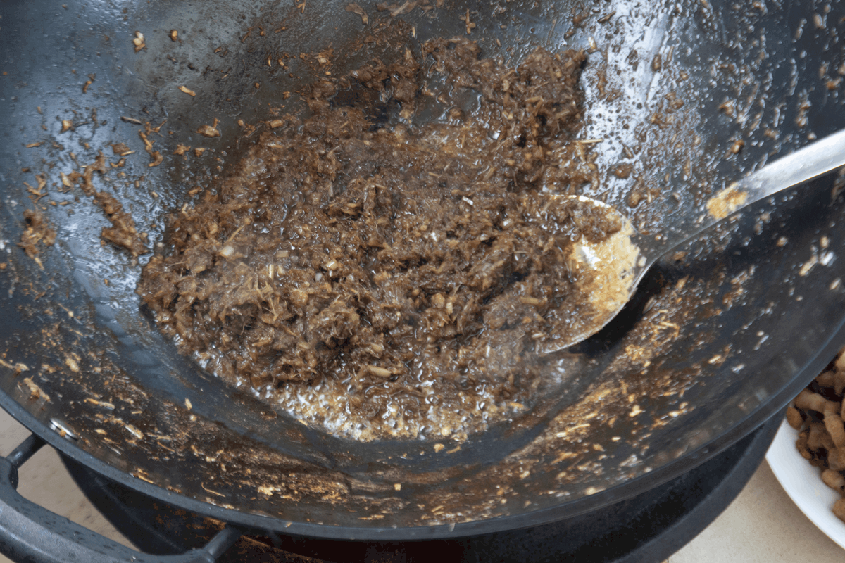 Lemongrass and shrimp paste in a wok.