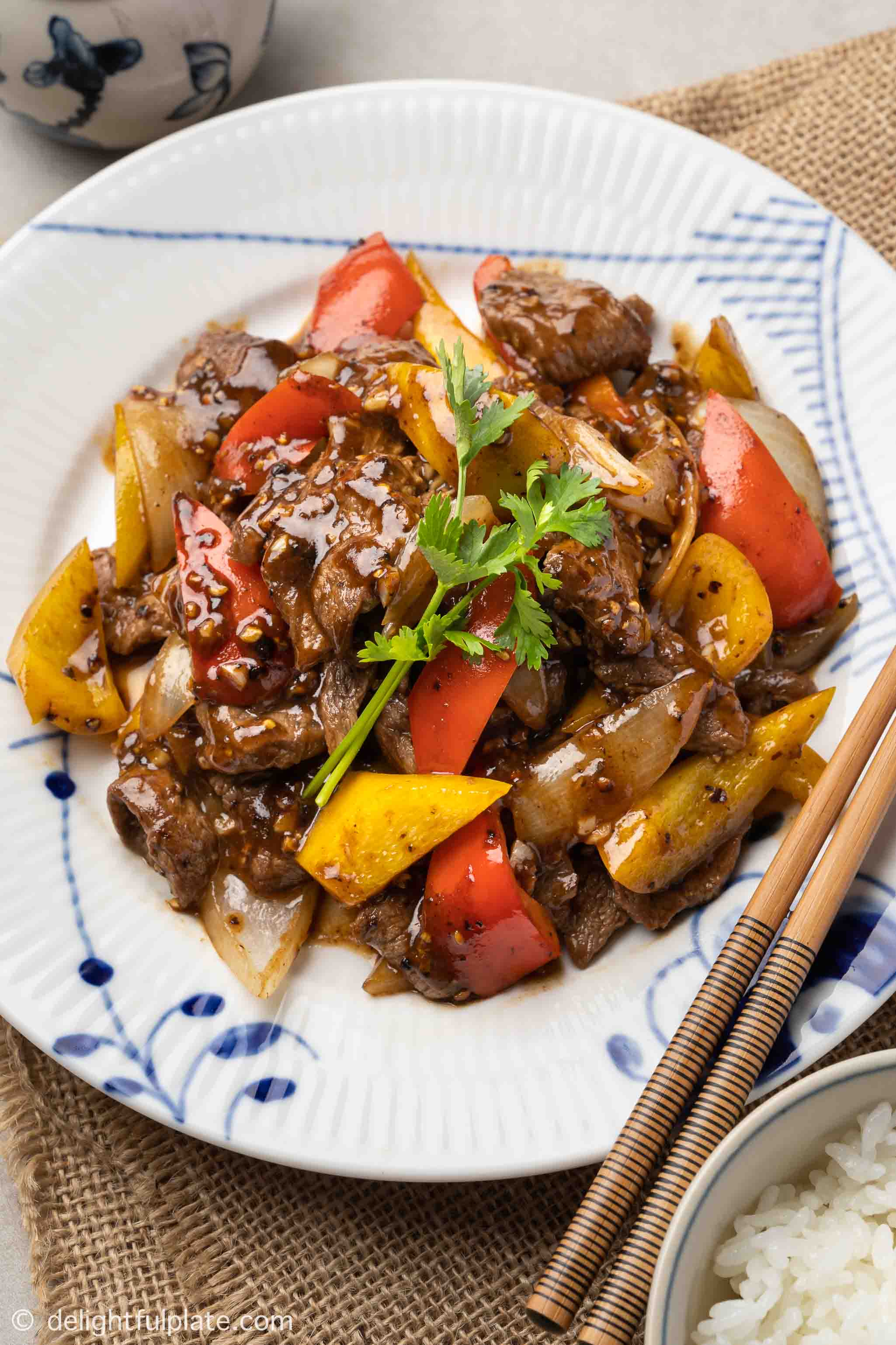 a plate of beef in black pepper sauce