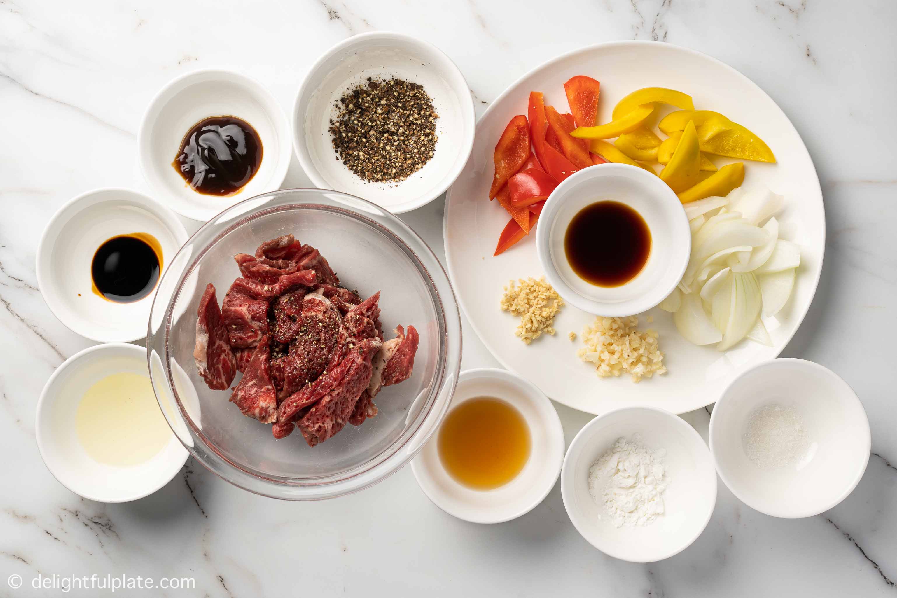 bowls containing with ingredients for black pepper beef