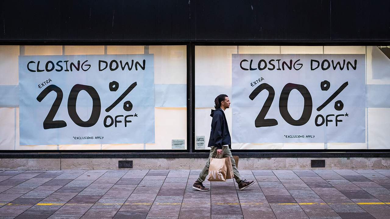 A pedestrian passes a "closing down" store sign in Cardiff, Wales, in 2023. (Matthew Horwood/Getty Images)