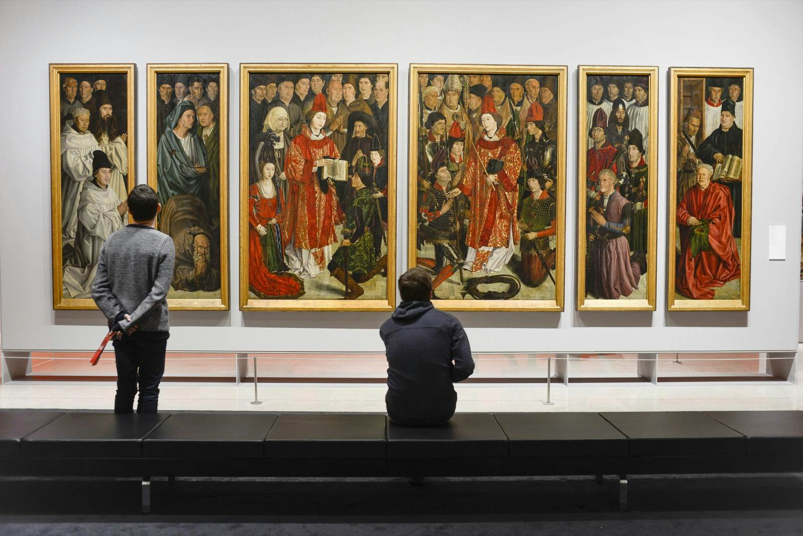 Two men look at a Renaissance painting in Lisbon's National Museum of Art