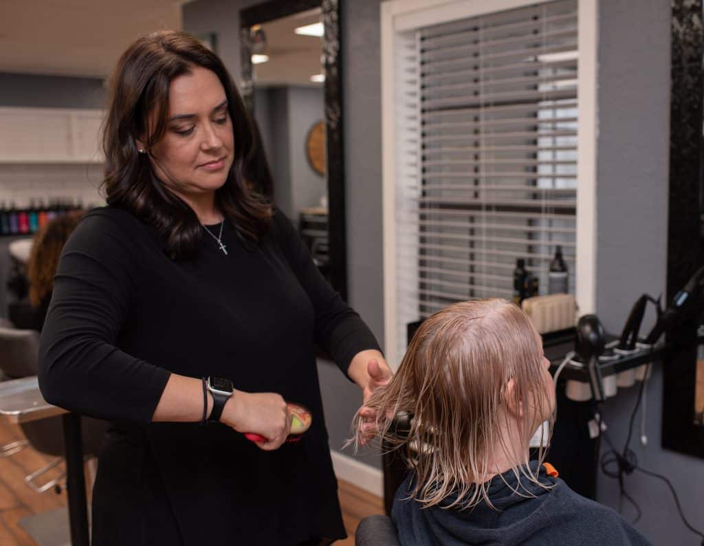 Hair stylist cutting a client